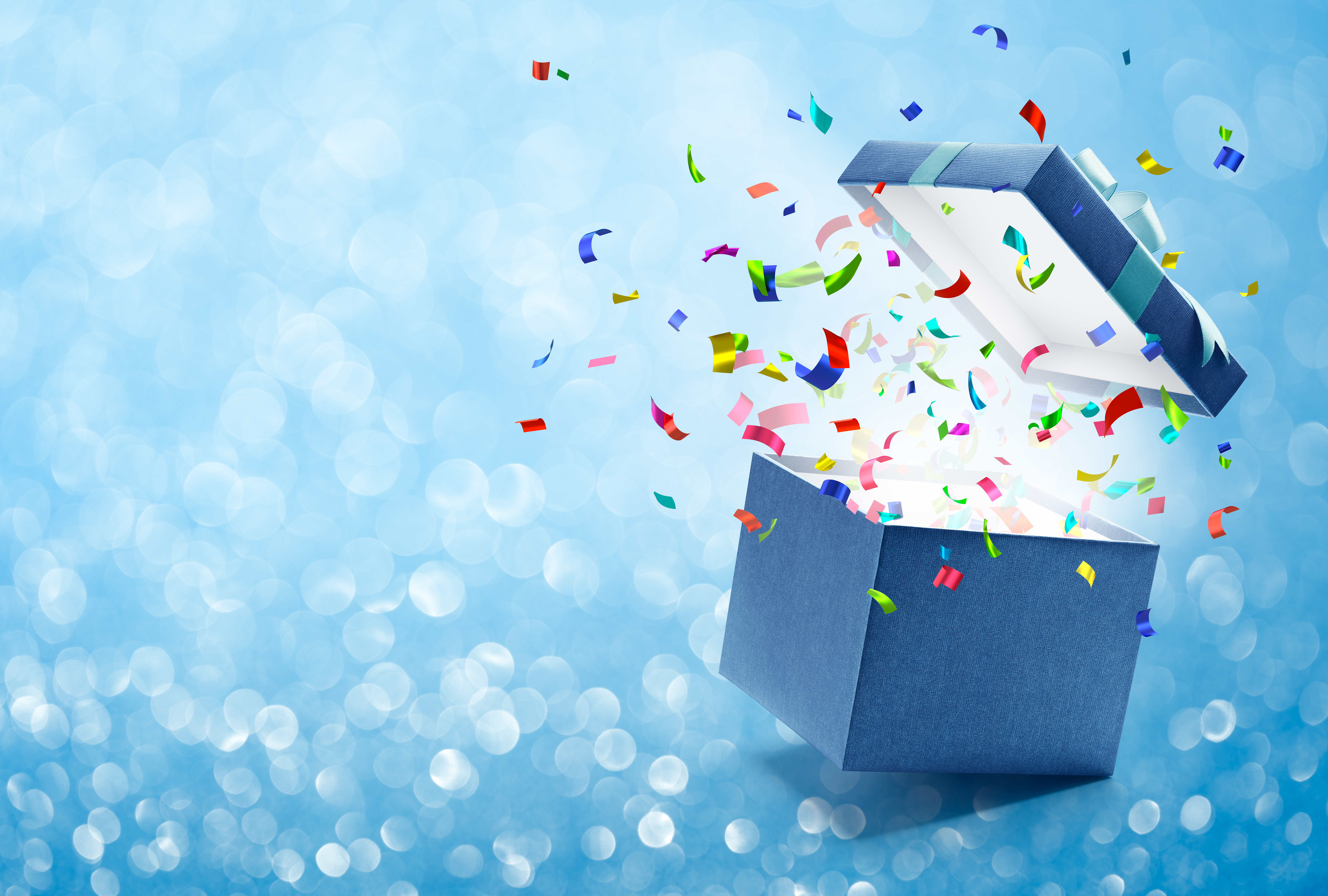 Confetti popping out from blue gift box